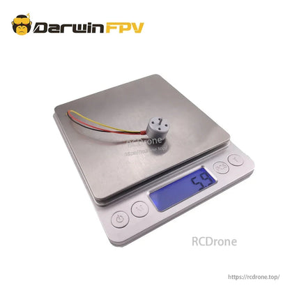 Darwin 1104 4300KV brushless motor on digital scale showing 5.9g weight