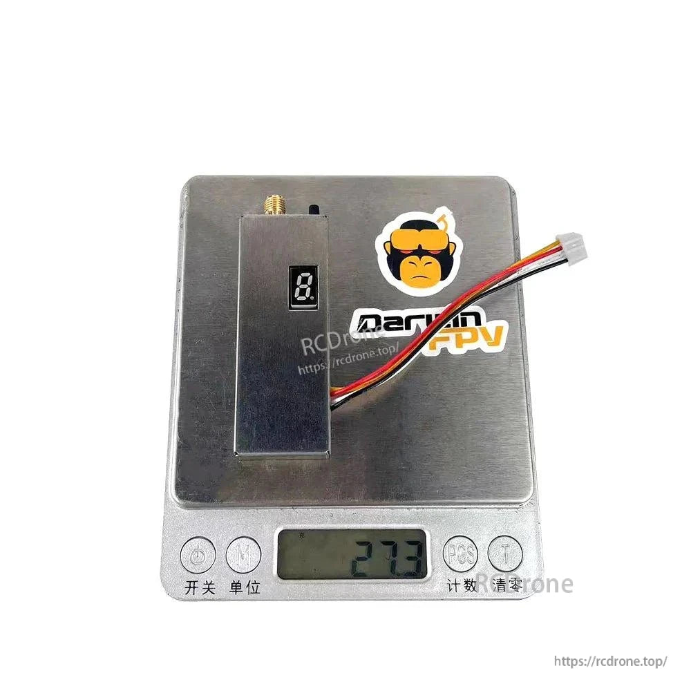 Video transmitter placed on digital scale showing 27.3 g weight