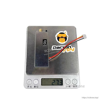 Video transmitter placed on digital scale showing 27.3 g weight
