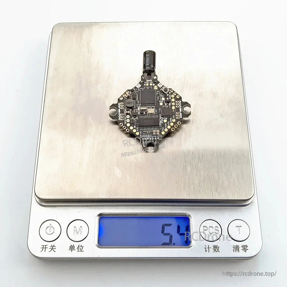 Ultralight AIO flight controller on digital scale showing 5.1 g weight