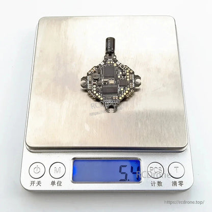 Ultralight AIO flight controller on digital scale showing 5.1 g weight