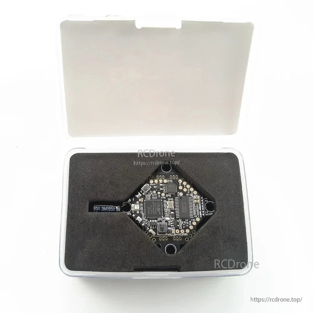 AIO flight controller stored in foam insert inside clear plastic carrying case, lid open