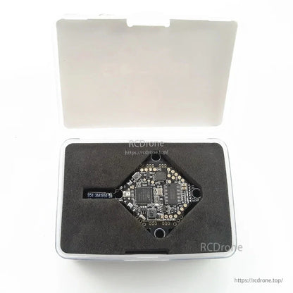 AIO flight controller stored in foam insert inside clear plastic carrying case, lid open