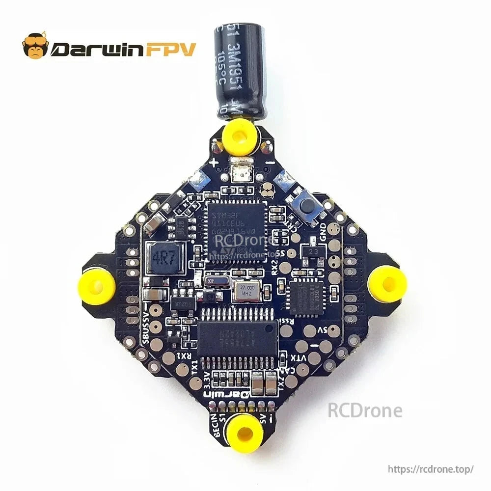 Top-down view of AIO flight controller board with labeled pads (5V, GND, TX/RX, SBUS) and capacitor