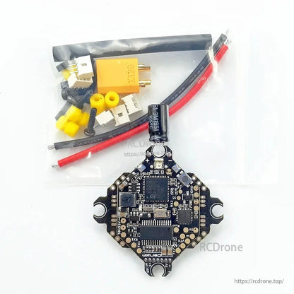 Package contents: DarwinFPV AIO FC board with capacitor, XT30 pigtail, wires, plugs, and gummies
