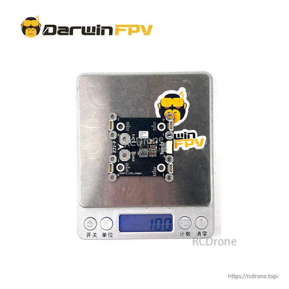 DarwinFPV power distribution board on digital scale showing weight reading, component side visible