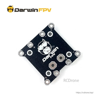 Angled rear view of Darwin FPV board with logo side, corner mounting holes, and solder pad positions