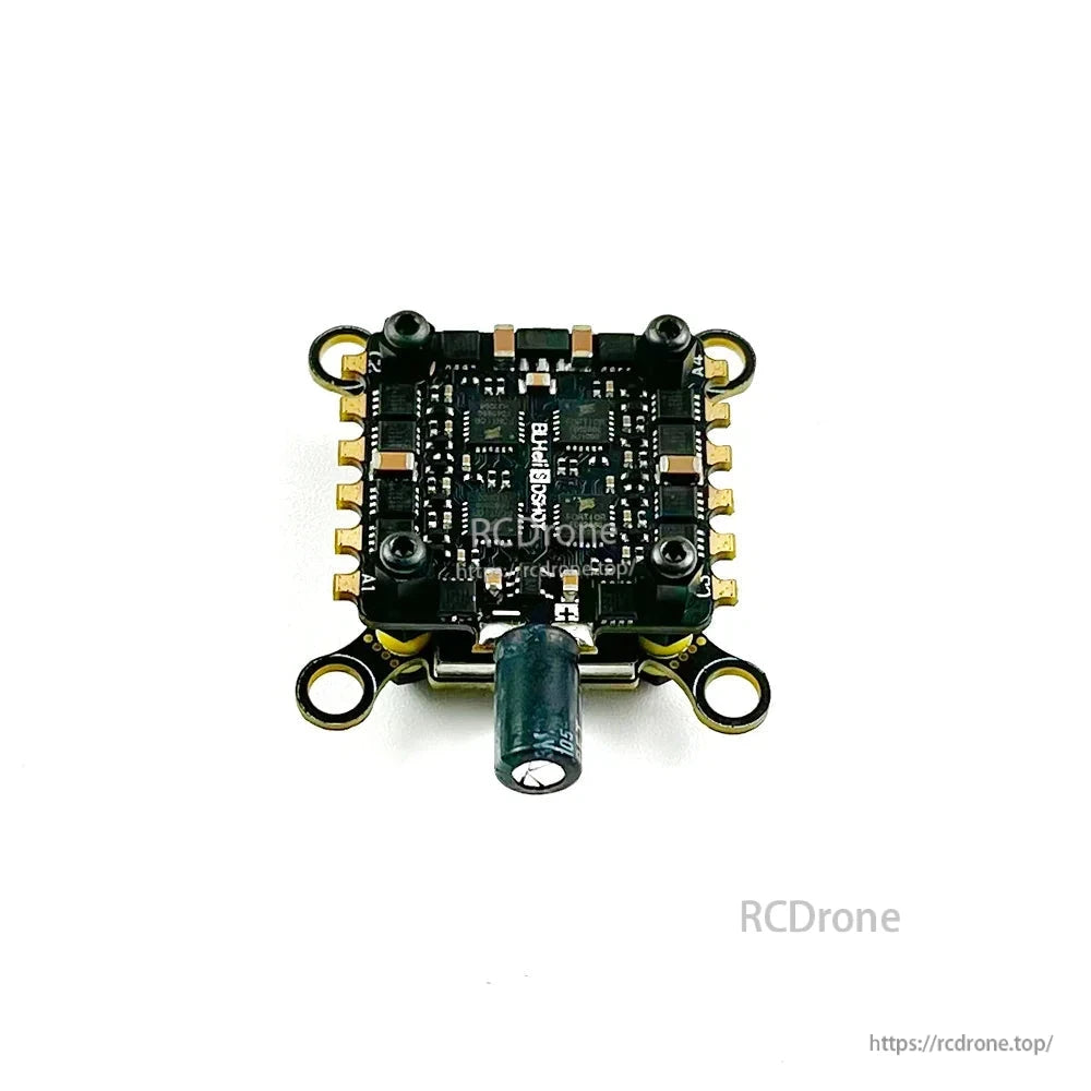 Underside of the FC/ESC stack showing processor side components and solder pads with capacitor installed
