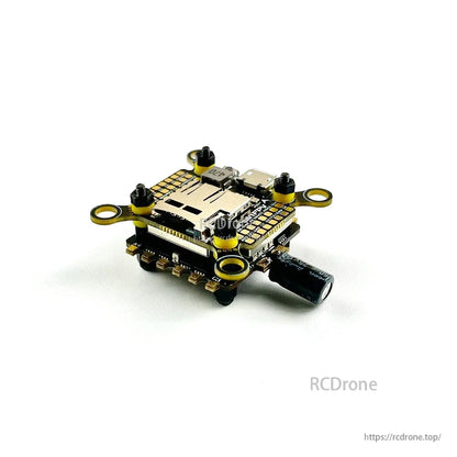 Angled side view of the FPV FC/ESC stack showing wiring pads along the edge and LC filter capacitor