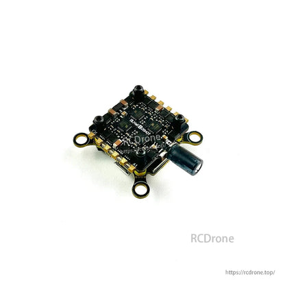Angled underside view of the stack showing chip layout, corner mounting holes, and capacitor position