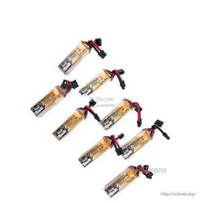 Seven DarwinFPV 3S LiPo batteries laid out in a set, showing labels and attached power leads
