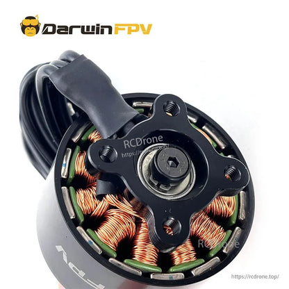 Bottom view showing copper stator windings, mounting plate and shaft hardware on the brushless motor