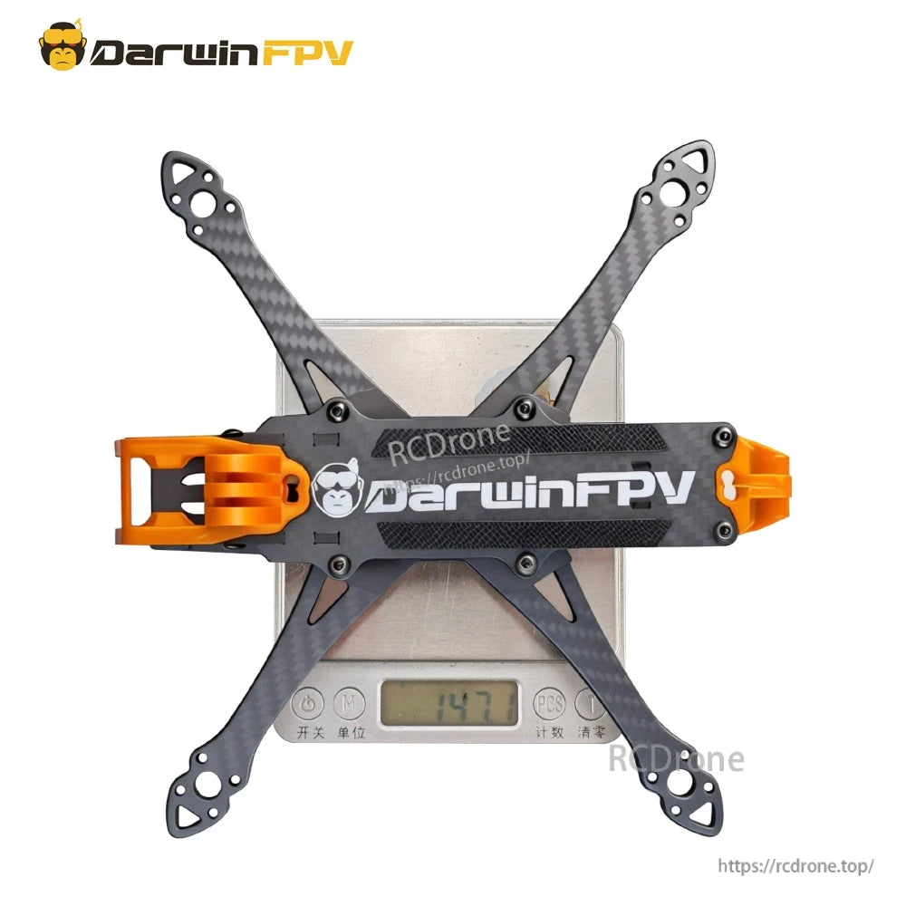 Frame on digital scale showing 147.7 g weight, top-down view with arms installed