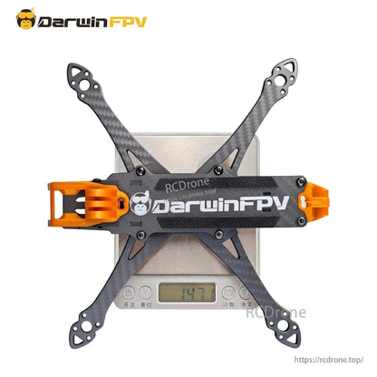Frame on digital scale showing 147.7 g weight reading, top plate with DarwinFPV logo