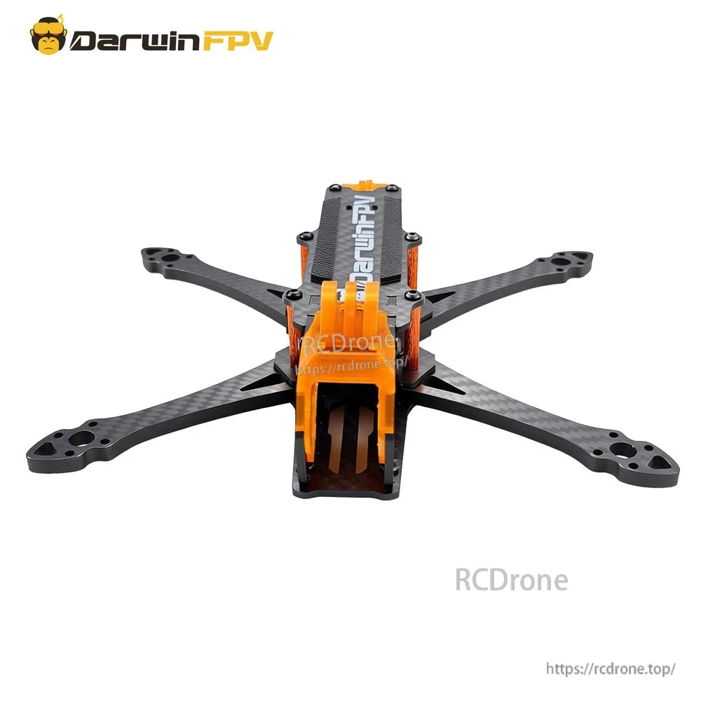 Front view of FPV frame with orange 20mm camera cage opening and carbon fiber arms spread