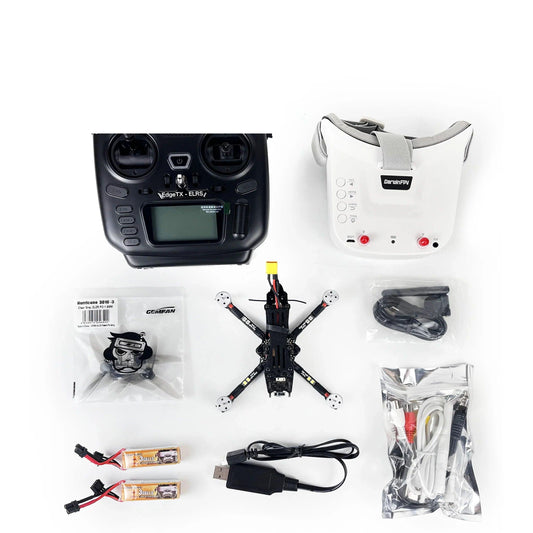 DarwinFPV RTF FPV drone kit flat lay with radio transmitter, FPV goggles, quadcopter, batteries and cables