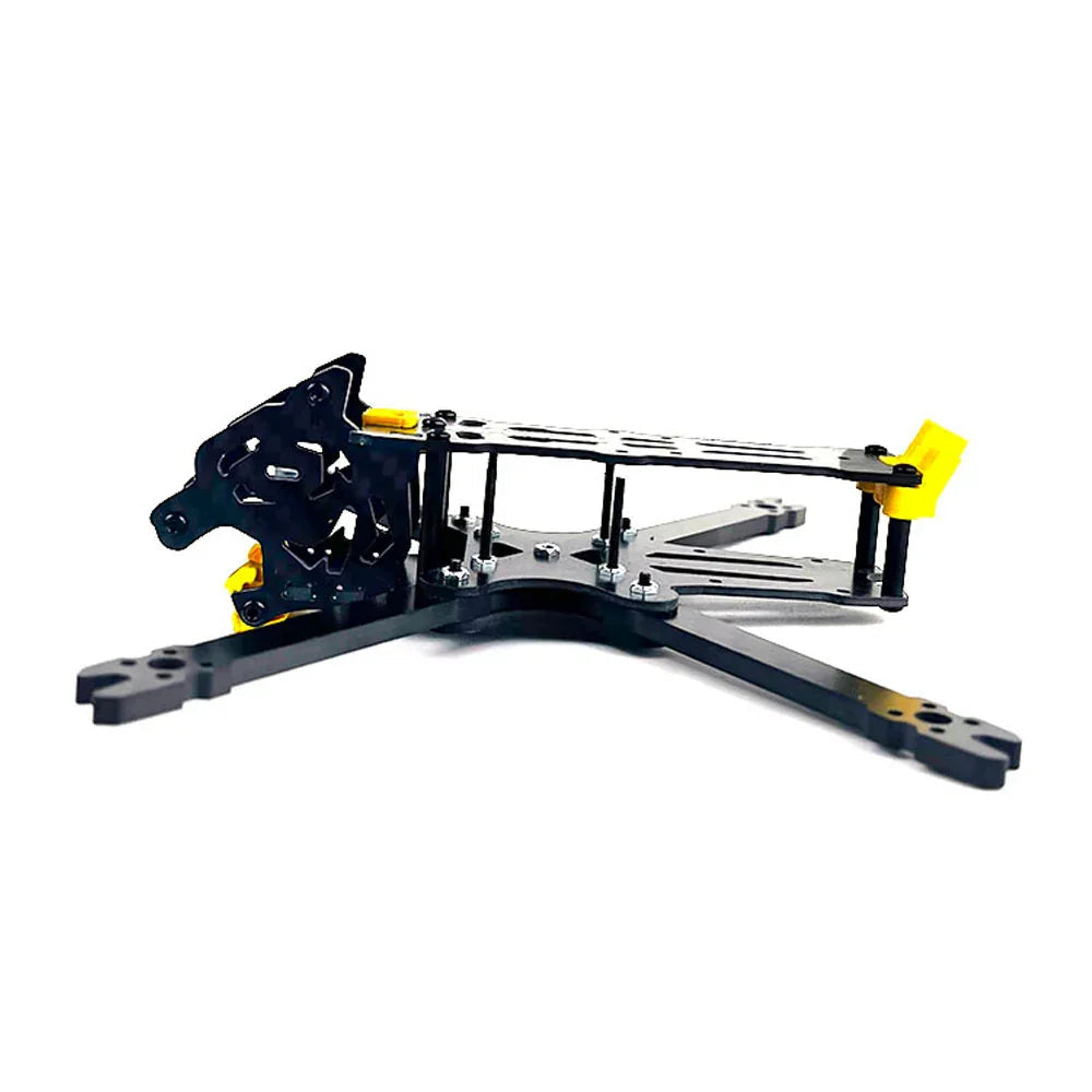 Angled view of FPV drone frame kit showing front carbon camera cage and arm mounting points