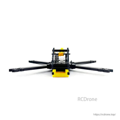 Rear view of BabyApe II carbon fiber frame with yellow rear bumper and top plate standoffs