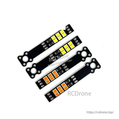 Four LED light boards for FPV drone build, two yellow and two orange LED arrays with mounts