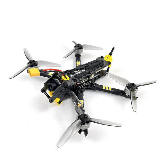 DarwinFPV FPV quadcopter drone, top angled view with four tri-blade props and yellow frame accents