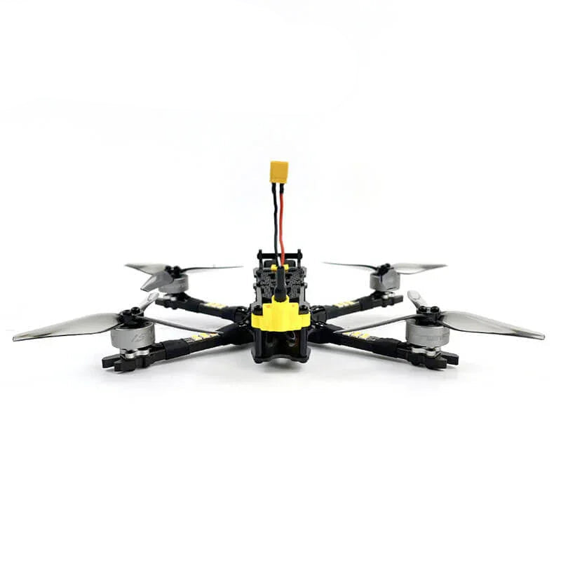 FPV quadcopter front view showing camera mount, battery lead and low-profile frame layout