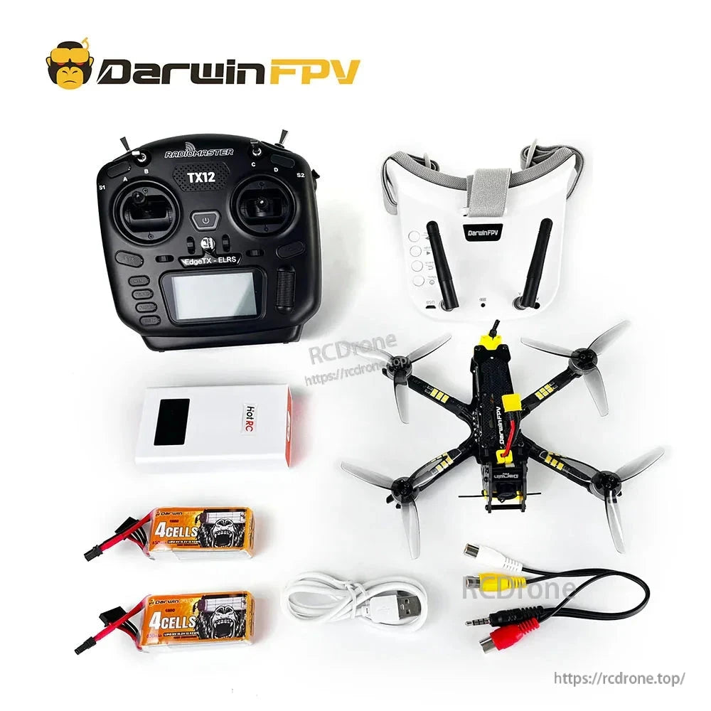 FPV quadcopter kit layout with TX12 transmitter, goggles, charger, two batteries, USB charging cable and AV adapter lead
