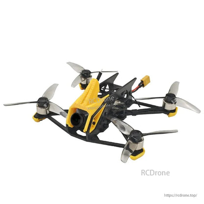 Front-left close angle of FPV quadcopter showing yellow camera canopy, frame braces, and propellers