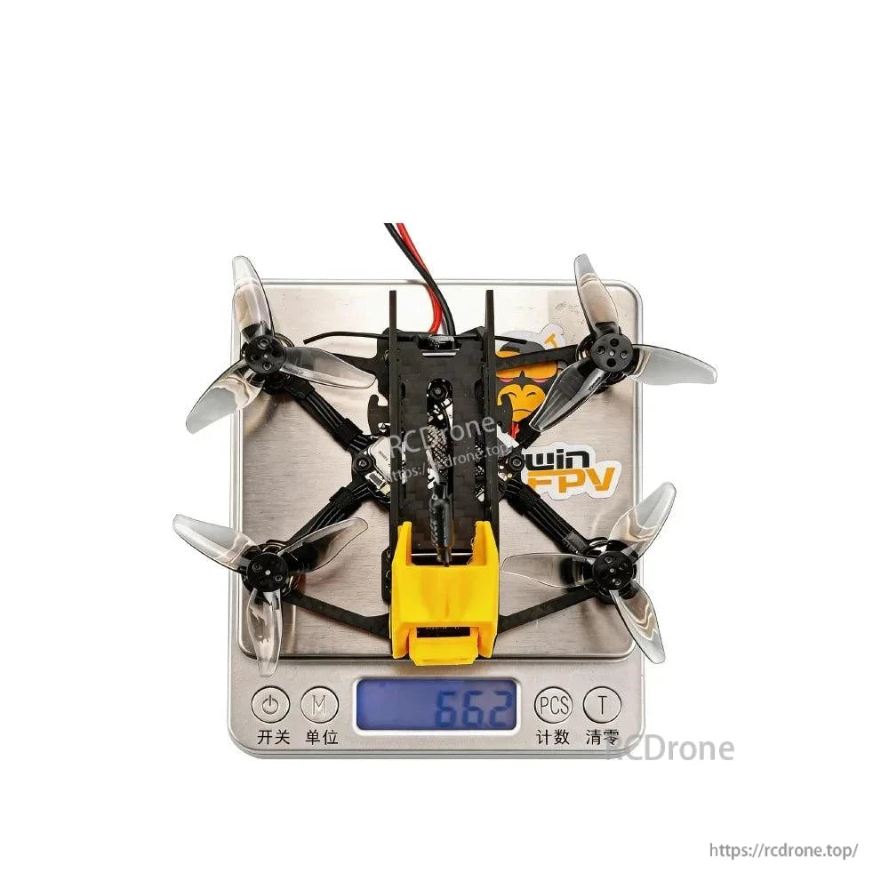 Top view of quadcopter on digital scale showing weight reading 56.2 g