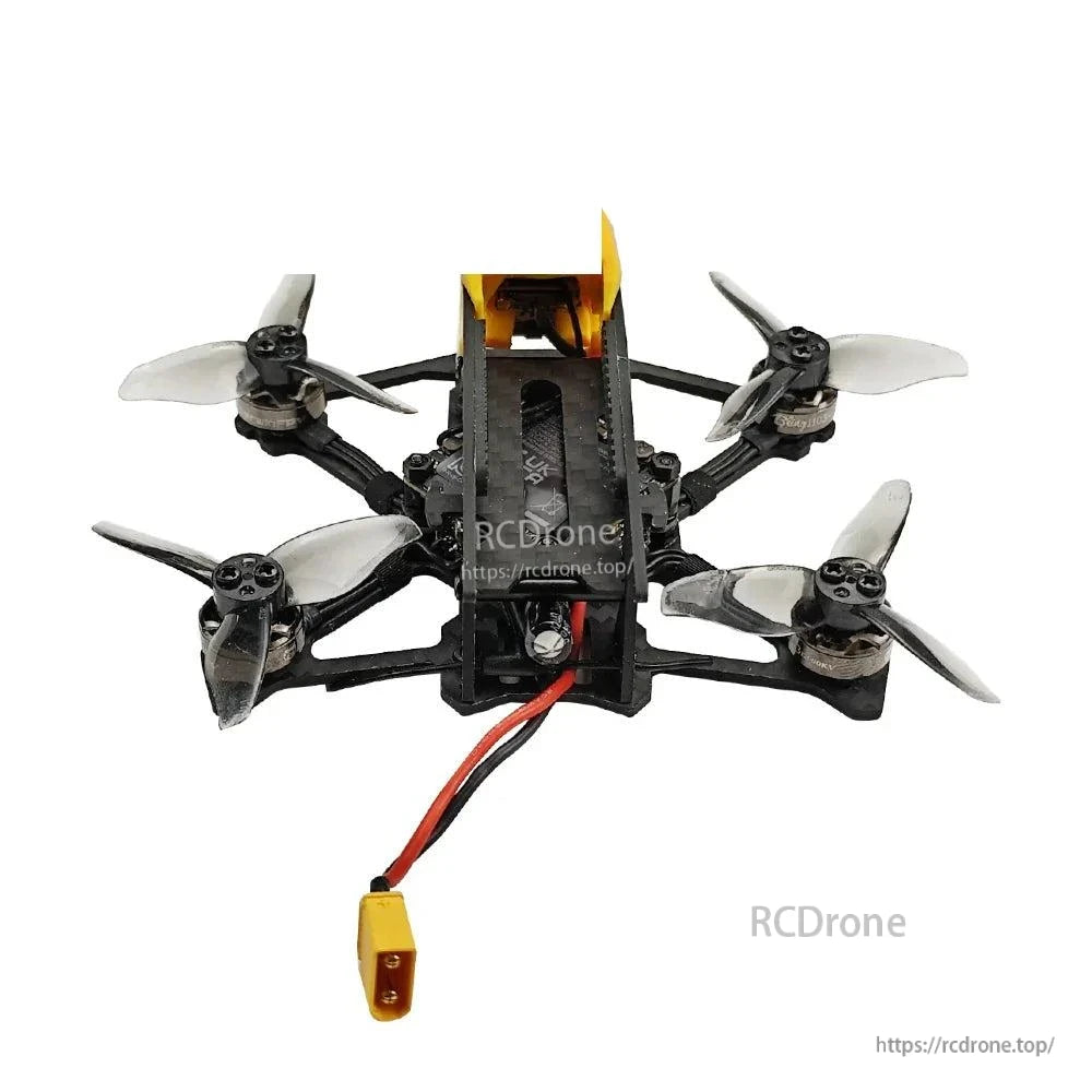 Bottom view of quadcopter frame with four motors and XT30 battery connector hanging below