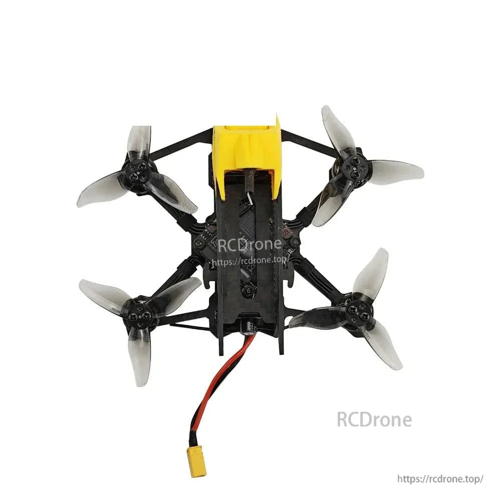 Top-down view of micro quadcopter showing canopy, prop layout, and battery lead exiting rear