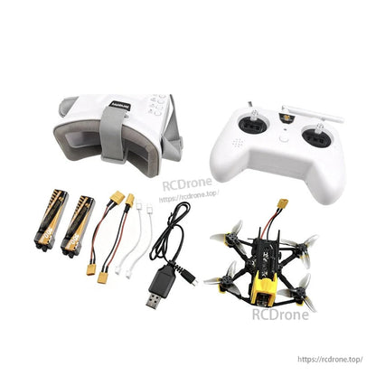 Complete FPV bundle laid out: goggles, transmitter controller, mini quad, USB charger, batteries and leads
