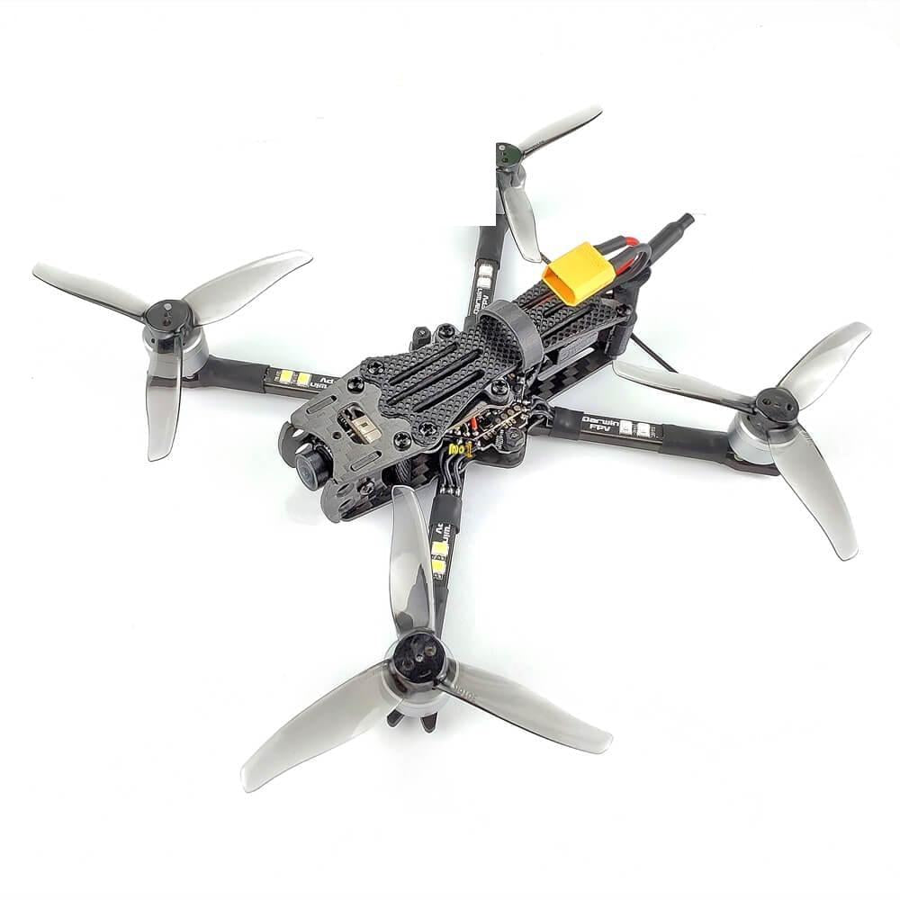 DarwinFPV FPV quadcopter drone top view with grey tri-blade props and XT60 battery lead