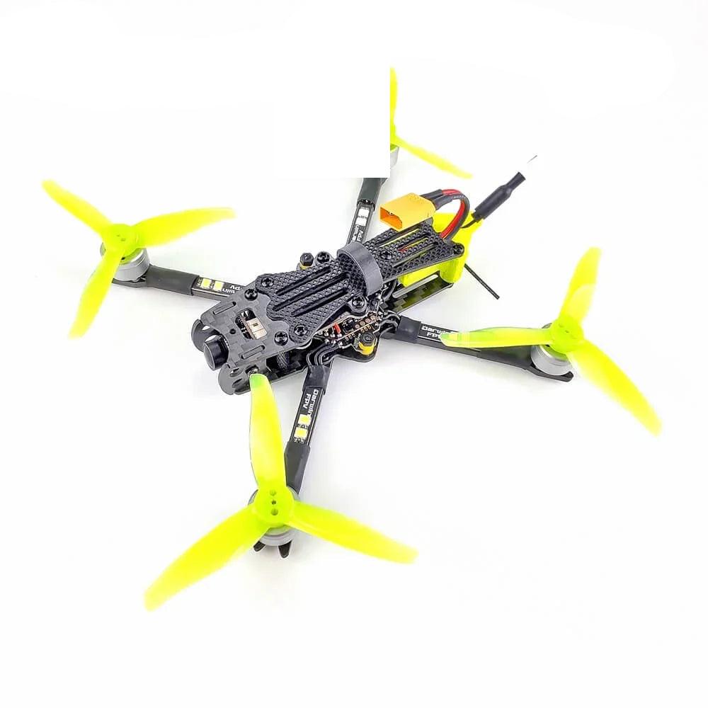 DarwinFPV quadcopter angled top view with neon yellow tri-blade propellers and carbon frame