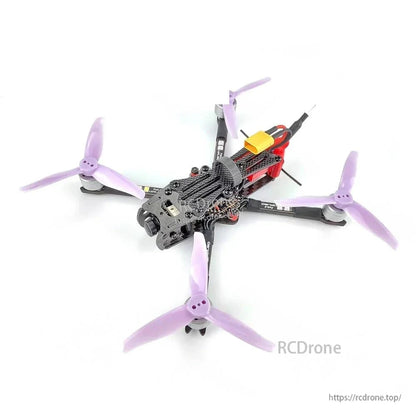 FPV quadcopter drone with purple tri-blade propellers, front camera mount, and battery strap
