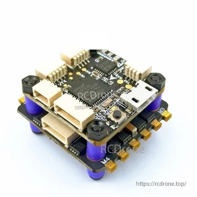 Angled view of stacked FPV controller with edge solder pads, USB port, and corner mounting screws