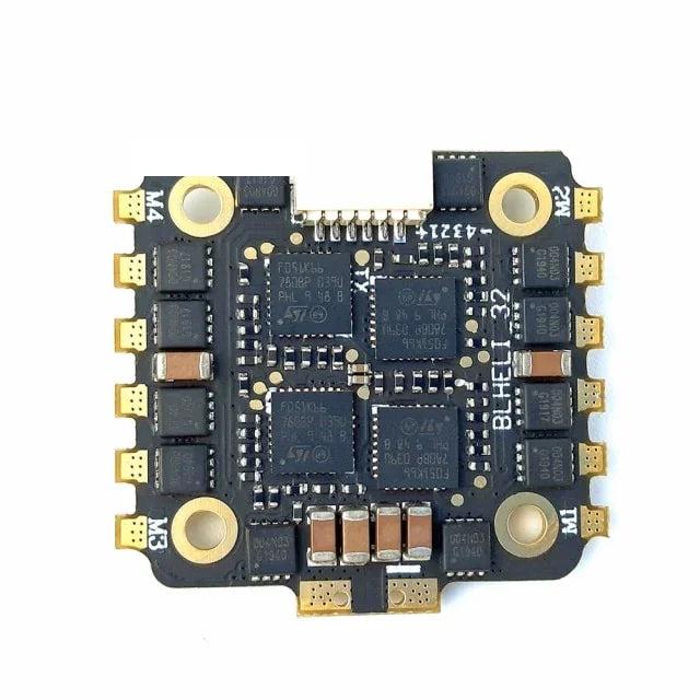 Bottom view of flight controller board with solder pads, MOSFET layout, and four mounting holes