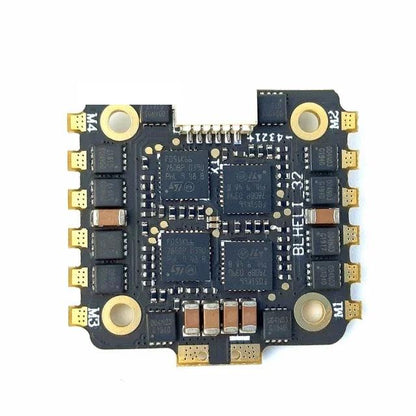 Bottom view of flight controller board with solder pads, MOSFET layout, and four mounting holes