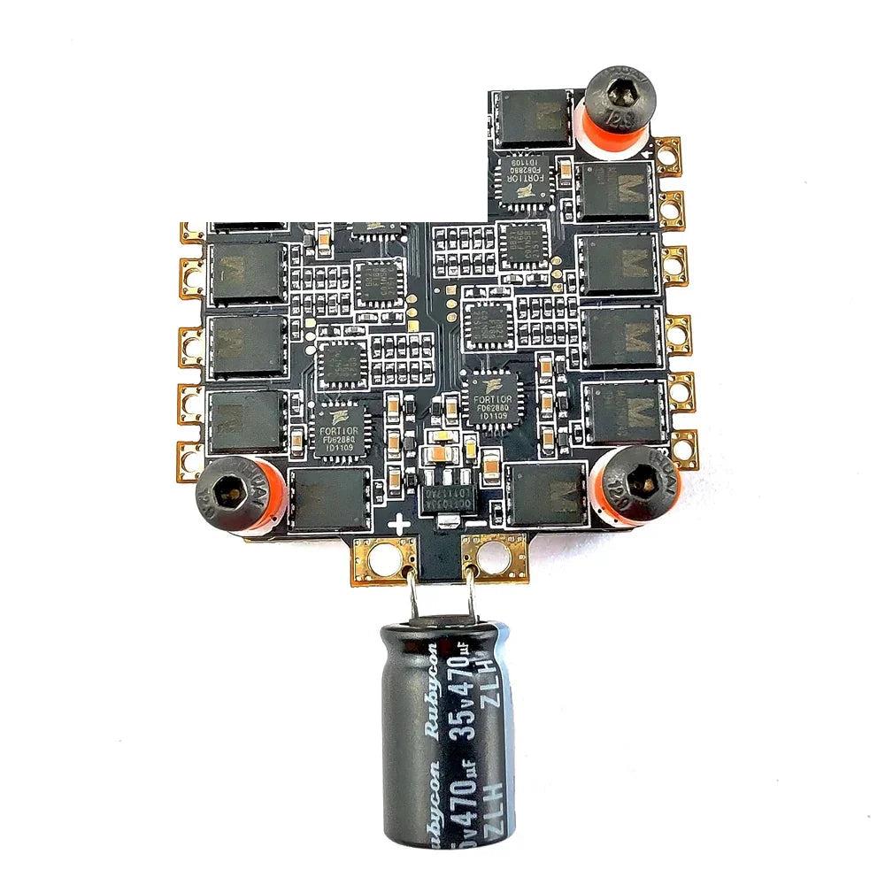 Underside of 4-in-1 ESC board with MOSFET array and attached electrolytic capacitor