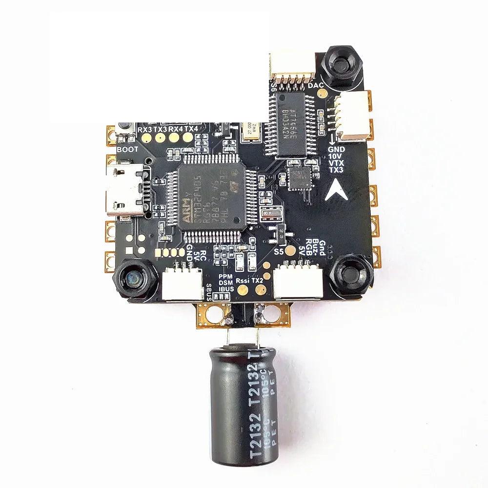Top view of flight controller showing USB port, BOOT button, and labeled solder pads (RX/TX, GND, VTX)