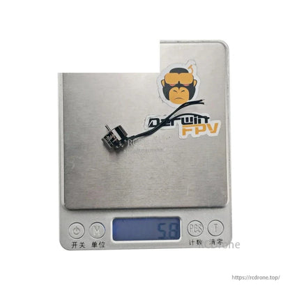 Motor weight shown on digital scale, reading 5.8 g