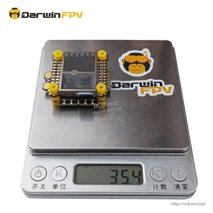 DarwinFPV Cement F4 FC + 60A ESC stack on digital scale showing 35.4 g weight