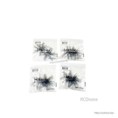Four HQProp sealed bags of 63mm 6-blade propellers arranged in a grid