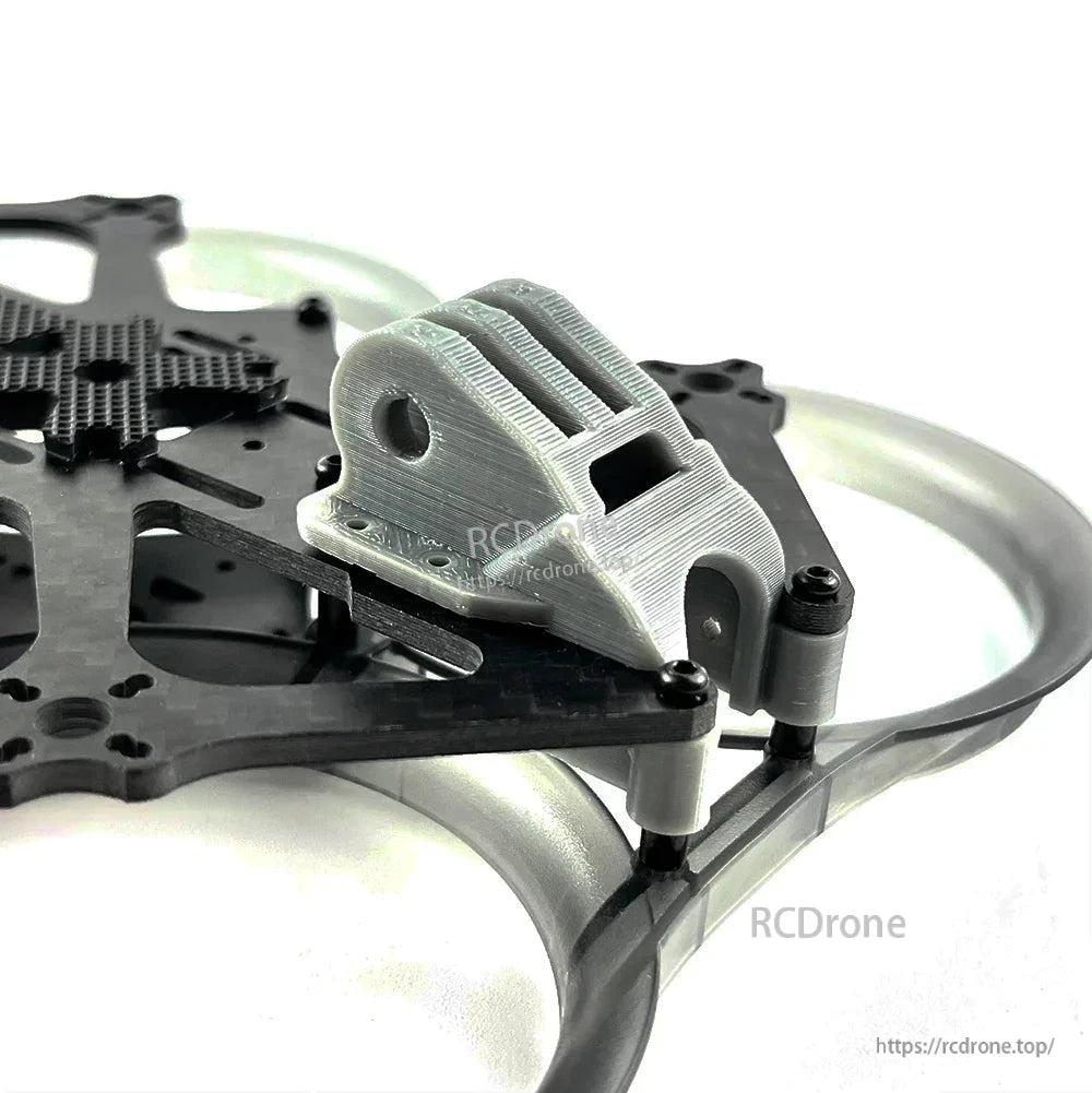Close-up of grey 3D-printed front mount and standoffs on the carbon fiber whoop frame