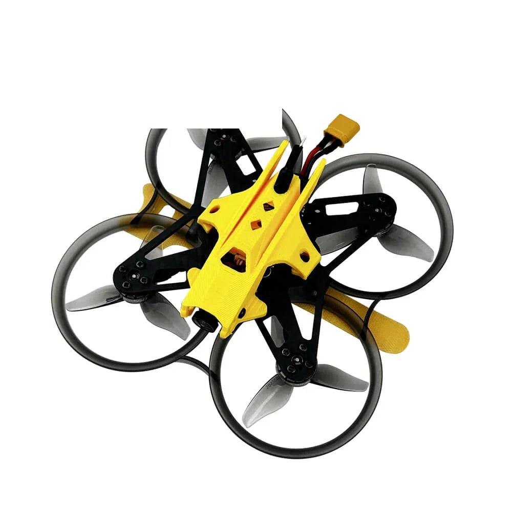 DarwinFPV ducted whoop FPV drone, top angled view with yellow canopy and battery lead