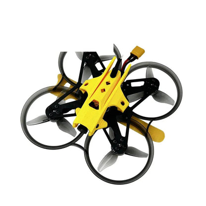 DarwinFPV ducted whoop FPV drone, top angled view with yellow canopy and battery lead