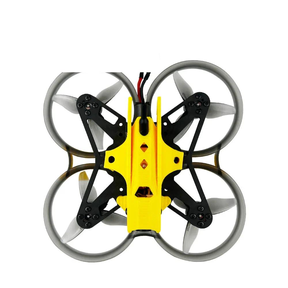 Top-down view of ducted whoop frame with yellow canopy, four prop ducts, and rear power cable