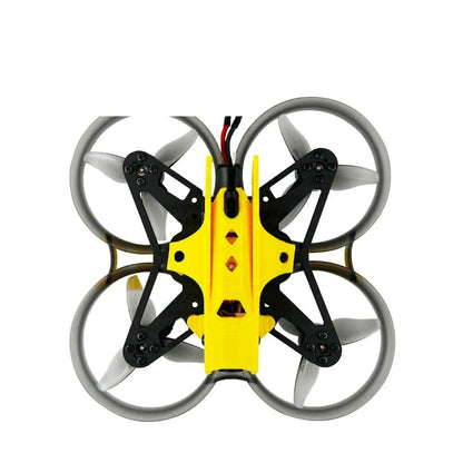 Top-down view of ducted whoop frame with yellow canopy, four prop ducts, and rear power cable