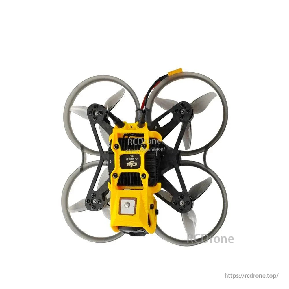 Centered underside view with square patch module and rear connector lead routed above prop ducts