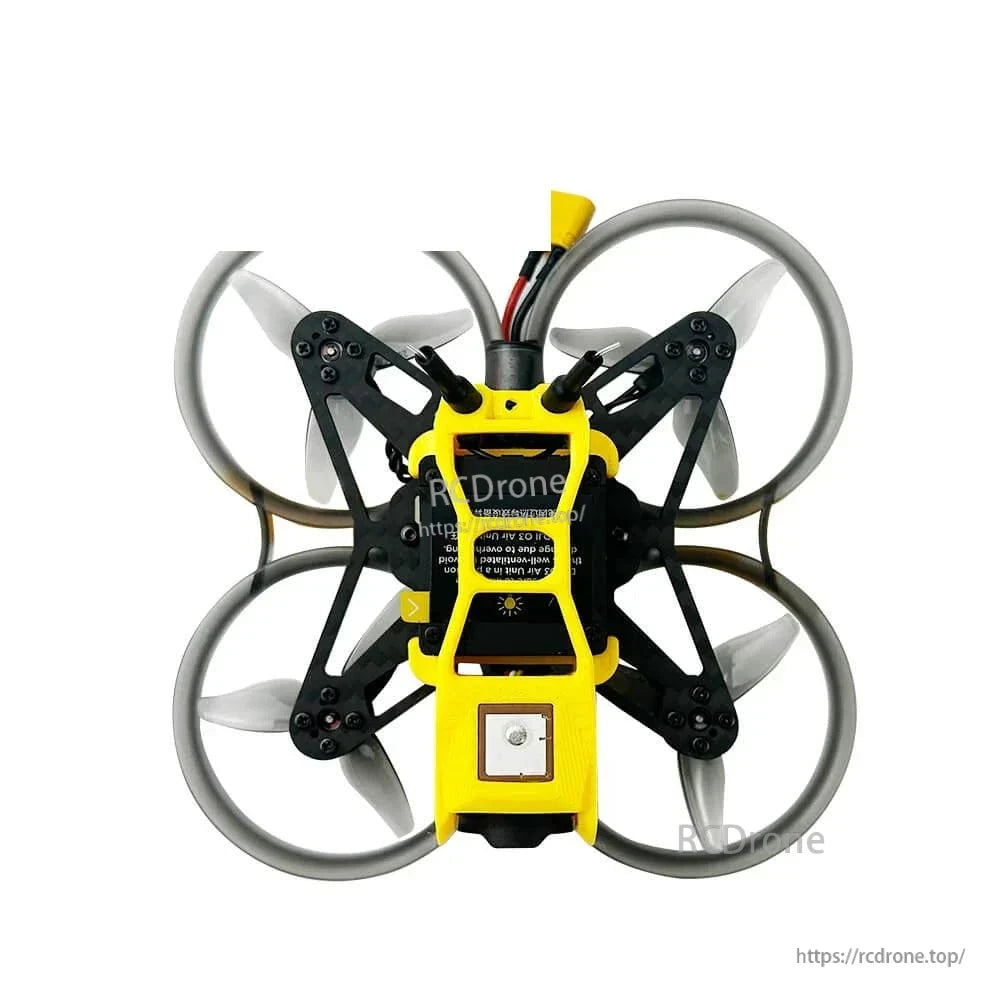 Bottom view showing square ceramic patch module and central electronics bay within yellow frame