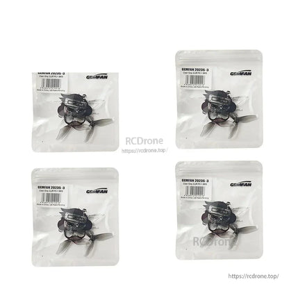 Four Gemfan 2023S-3 clear gray propeller packs arranged in a 2x2 layout